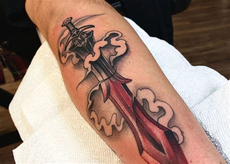 inner forearm sword tattoo|sword with snake tattoo.